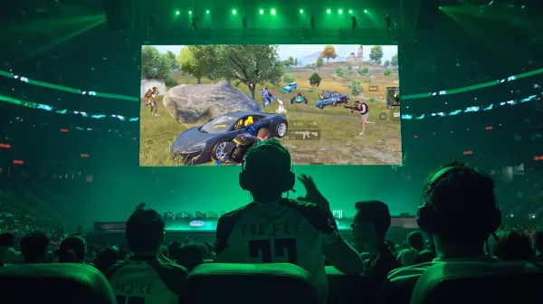 Players cheering in a stadium watching BGMI/PUBG Mobile on the screen